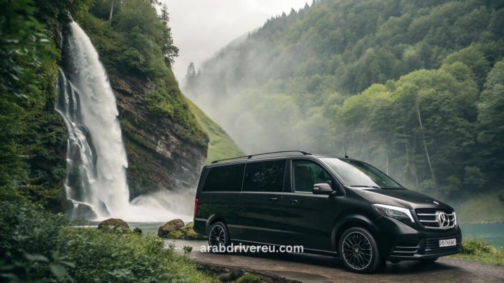 سائق عربي محترف في سويسرا يقود سيارة فاخرة (مرسيدس V-Class) لنقل خاص بين زيورخ وجنيف مع خلفية جبال الألب وبحيرة