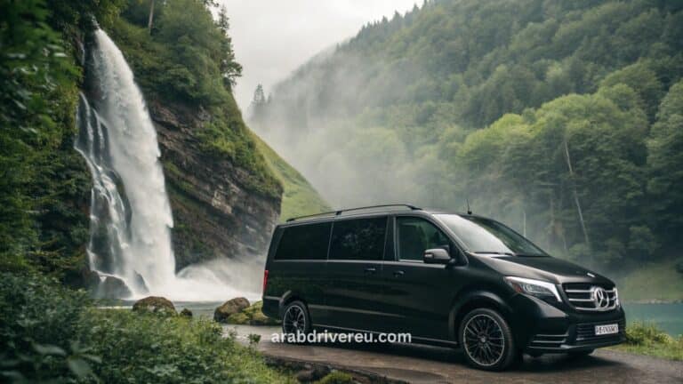 سائق عربي محترف في سويسرا يقود سيارة فاخرة (مرسيدس V-Class) لنقل خاص بين زيورخ وجنيف مع خلفية جبال الألب وبحيرة